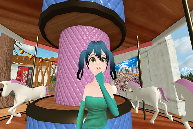 A girl with pigtails covering her mouth in front of a carousel