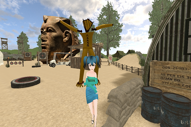 A girl with pigtails dance battling with the Burning Man with the Granite head of Amenemhat III in the background