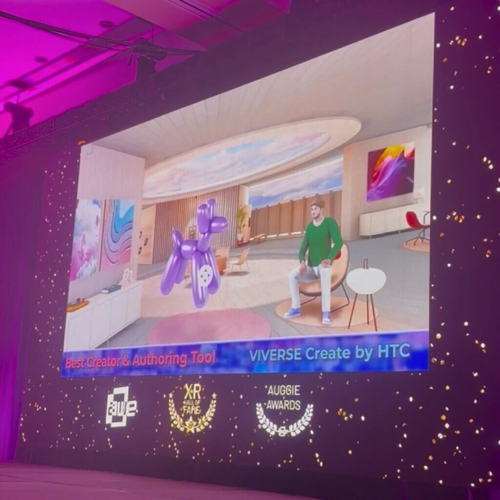 A projected screen at the 2025 Auggie Awards. The screens displays 'VIVERSE Create by HTC' is a finalist for Best Creator & Authoring tool.