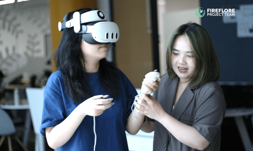 A participant tries Firefly Memories for the first time at Fulbright University Vietnam, guided by a team member