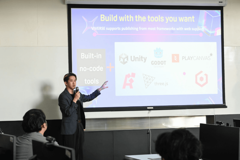 Presenter pointing to a slide showing VIVERSE built-in no-code tools alongside game engines including PlayCanvas