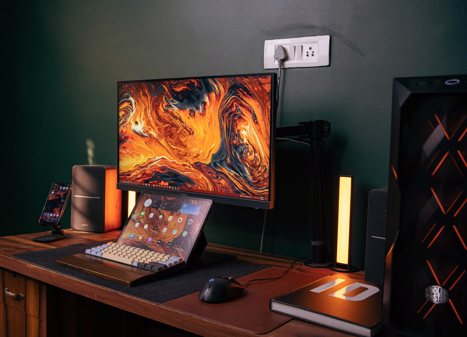 A modern game development workspace with laptop and monitor showing the triple-A gaming and indie studio split