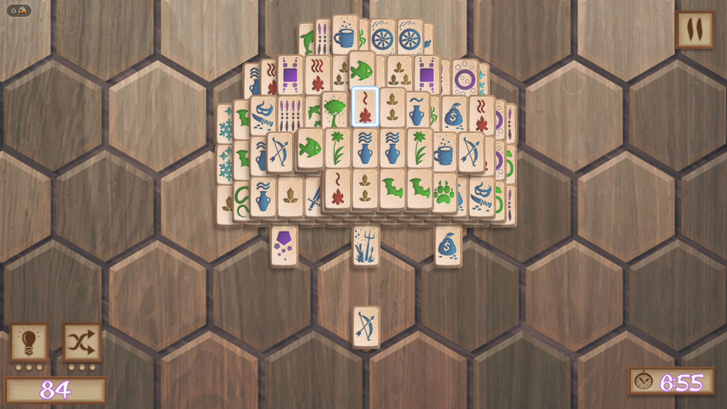 Mahjong Classic tile board mid-game with a stacked pyramid of matching symbol tiles.